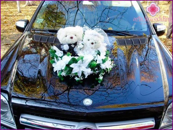 Toys on the hood of a wedding car