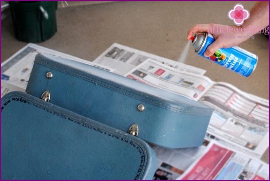 Coat the suitcase with spray paint