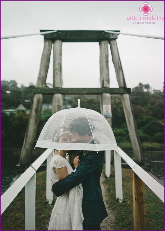 Transparent umbrella for a wedding photo shoot