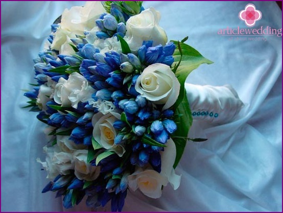 Bridal bouquet of white roses in addition with blue flowers