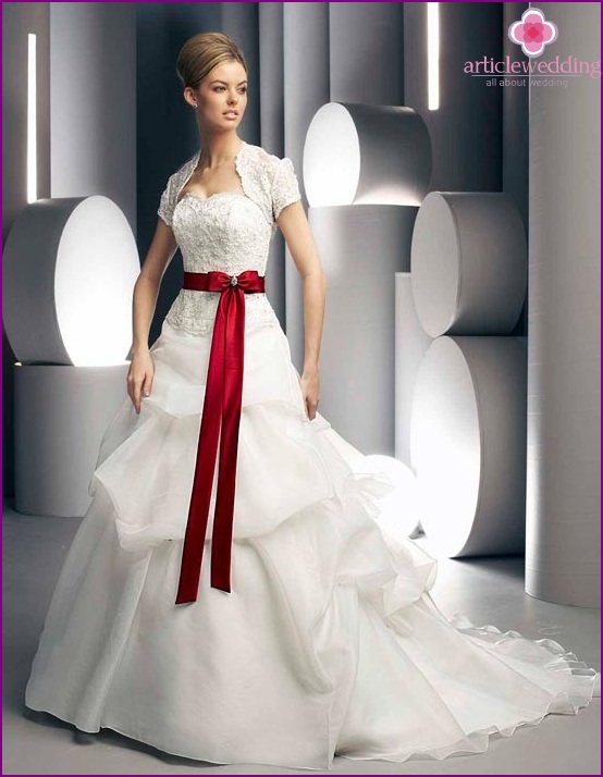 A fluffy white dress with a cherry burgundy belt