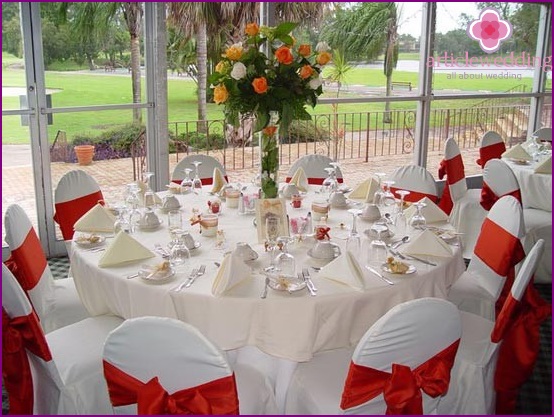 Red and white decor of wedding chairs