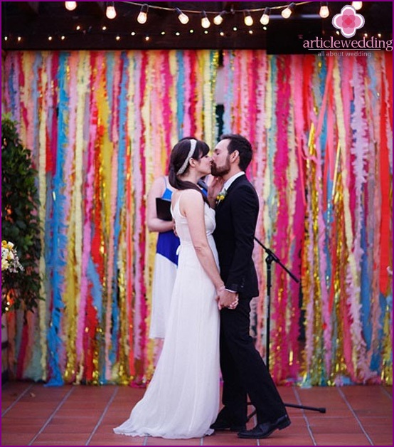 Newlyweds on the background of bright garlands