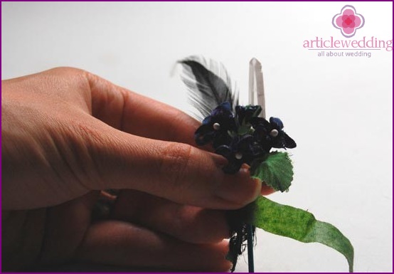 Add greens to the boutonniere