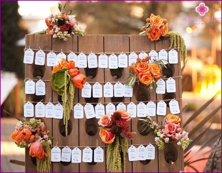 Escort card on a stand with flowers