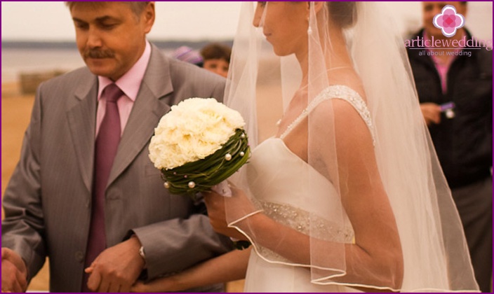 Bride with carnations in a bouquet