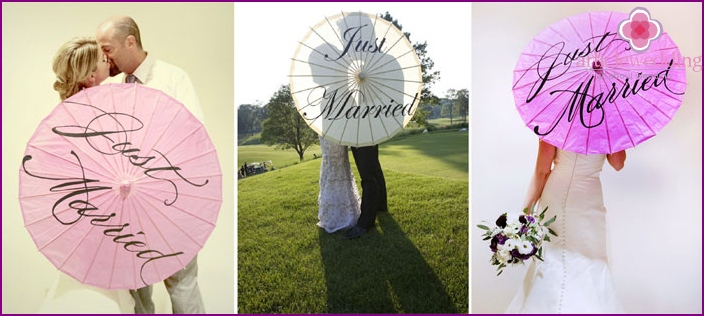 Newlyweds with an umbrella in the photo