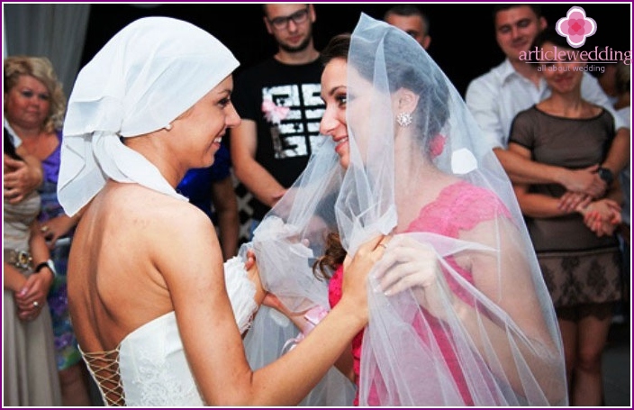 Bride and unmarried girlfriend are dancing together